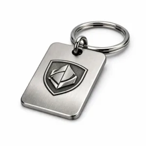 A brushed stainless steel keychain tag featuring softly rounded corners and a laser-engraved blank emblem, presented on a split ring. High-detail studio shot, ideal for showcasing durable metal tag options.