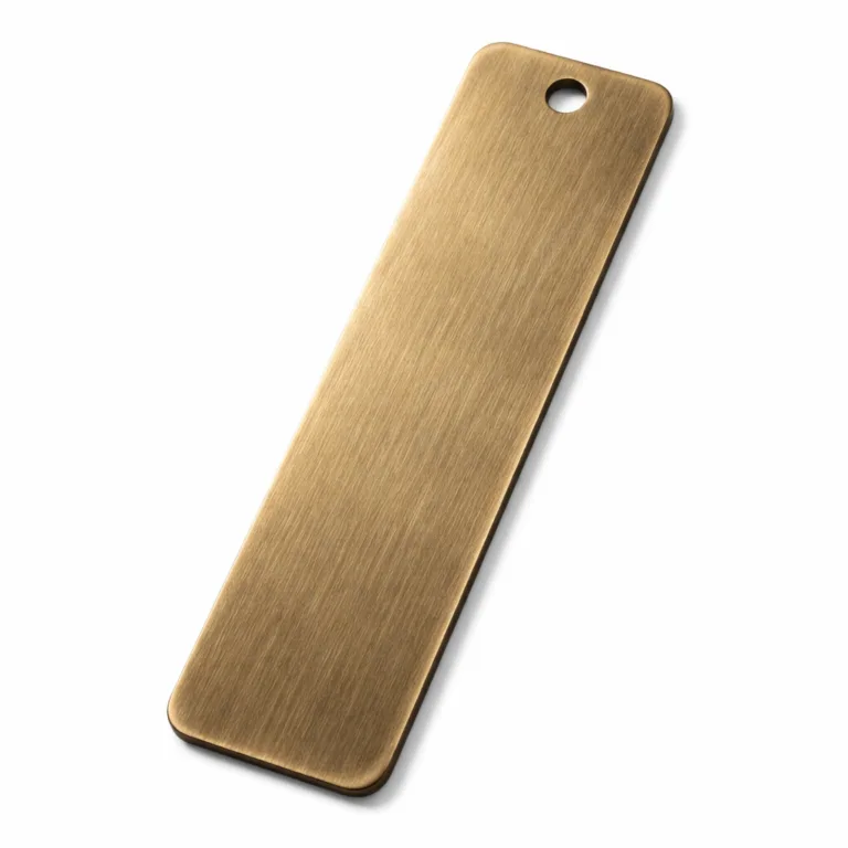 This variant of the Antique Brass Bookmark Tag is made of solid brass with an antique brass finish and a brushed surface texture. It features smooth, rounded corners and a single hole at the top, ideal for adding a tassel or cord.