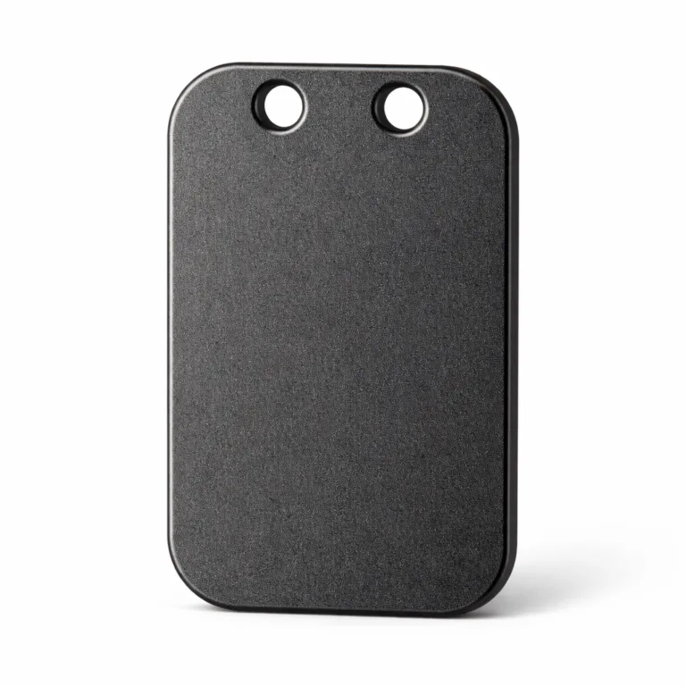 A zinc alloy bag tag featuring a matte black nickel plated finish and sandblasted surface. The tag has gently rounded corners and double holes for a ball chain, providing a contemporary, durable accessory.