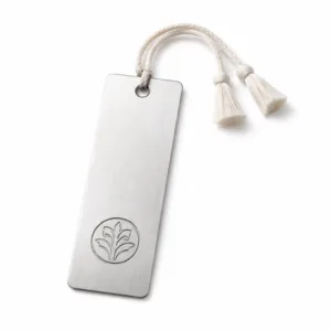 Premium bookmark tag crafted from brushed stainless steel, featuring a recessed emblem logo and gently rounded corners. Ideal for marking book pages, the brushed finish highlights the metal's texture for a modern look.