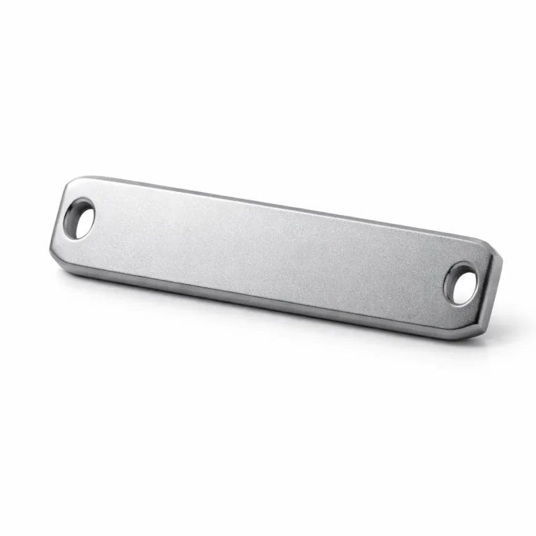An anodized aluminum bracelet nameplate with a sandblasted matte finish, smooth beveled edges, and double holes for easy strap mounting. Modern, lightweight, and suitable for various bracelet designs.
