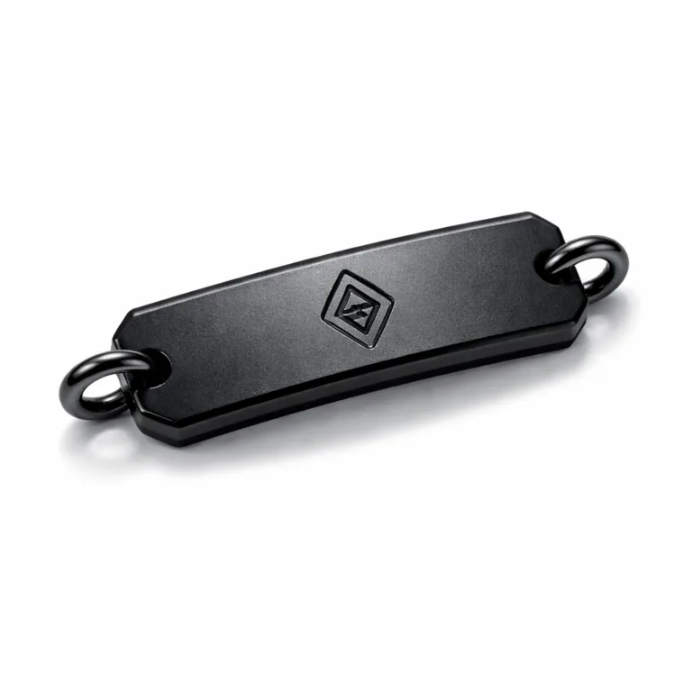 An anodized aluminum bracelet tag finished in matte black nickel, featuring a debossed blank emblem and beveled edge for a modern look. Photographed individually in a white background studio setup.