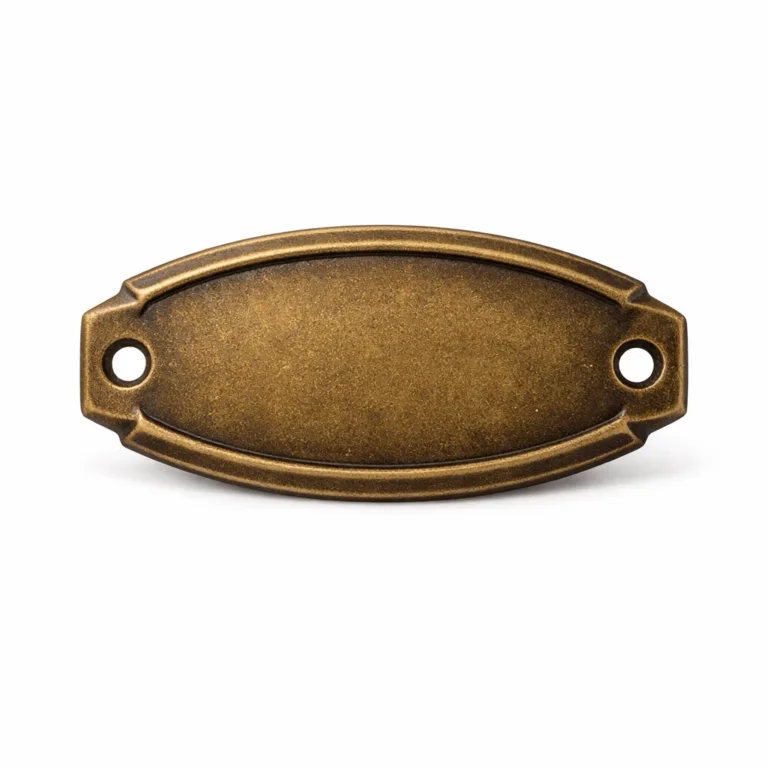 Oval-shaped bracelet tag plated in antique brass, featuring a debossed blank emblem at the center, chamfered edges, and discreet sewing holes at both ends for easy attachment onto fabric or leather bracelets.