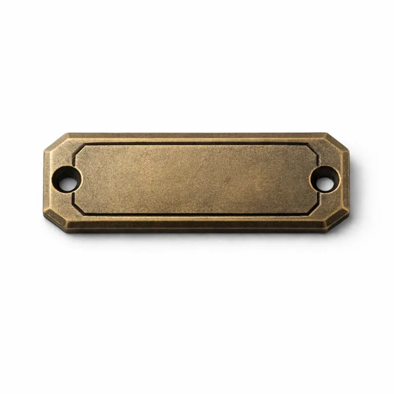 Matte nickel bracelet tag with antique brass plating over zinc alloy, featuring an embossed blank emblem for subtle branding. Chamfered edge design and dual screw holes provide a secure and fashionable attachment to metal or leather bracelets.