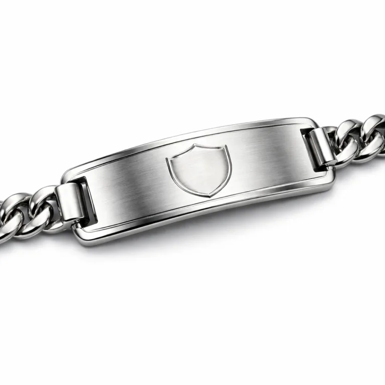 A single bracelet tag made from brushed stainless steel, featuring a polished surface and a blank laser-engraved emblem. The tag has rounded corners and is photographed on a white studio background with high realism and sharp detail.