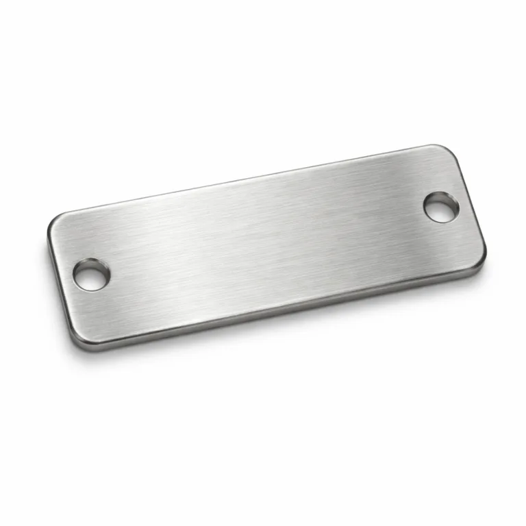 A garment tag designed in a brushed stainless steel finish, featuring a rectangular shape with smoothly rounded corners and two sewing holes on each end. The front displays a clean, etched blank logo area suitable for custom branding.