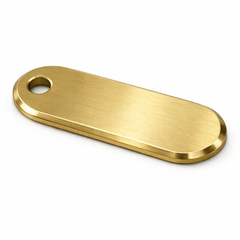 A solid brushed brass bag tag plate featuring a sleek beveled edge, an oblong shape, and a single hole for easy attachment. Perfect for adding a premium look to luggage or bags.