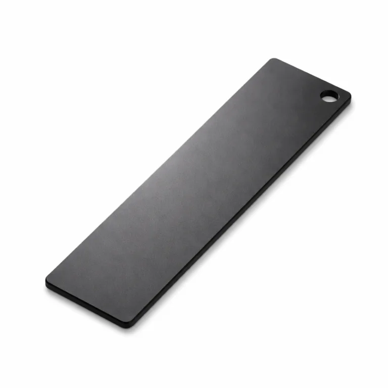 This sleek anodized aluminum bookmark features a matte black finish and a single hole in the corner, making it versatile for both marking and light attaching.