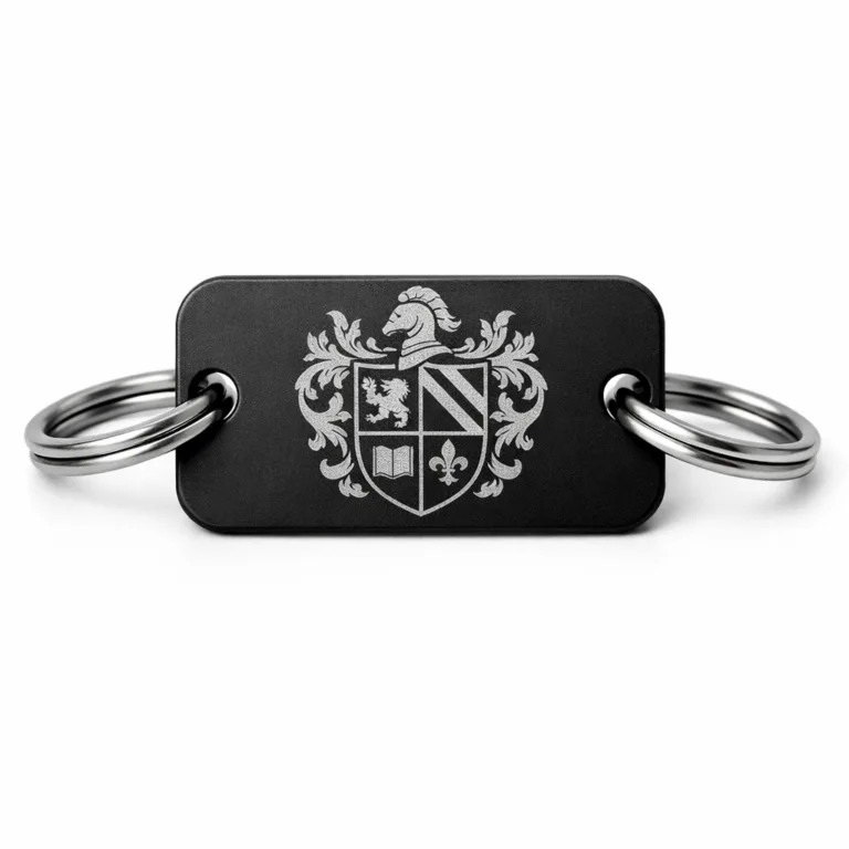 Matte black anodized aluminum crest bracelet tag with finely etched crest emblem, rounded corners, and a split ring attachment. The image highlights the tag's sleek finish and crisp edge details, optimized for e-commerce viewing.