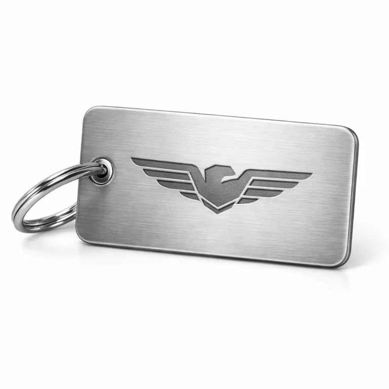 A premium brushed stainless steel effect luggage tag featuring rounded corners and a subtle laser engraved blank emblem, attached to a split ring for easy use. Ideal for travel with a sleek modern design.