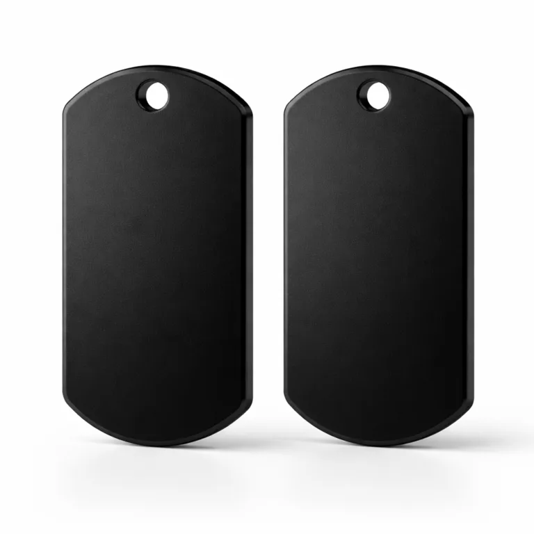 A double-sided dog tag crafted from matte black anodized aluminum, designed with a beveled edge for a modern look. Features a single attachment hole and sleek black appearance, photographed in crisp studio conditions.