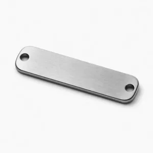 High realism studio photo of a brushed stainless steel bracelet tag for emergency contact, manufactured with rounded corners, dual holes for bracelet attachment, and laser engraving for a subtle blank emblem. Durable and modern appearance.