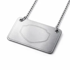 A realistic studio image of a brushed stainless steel Frame Logo Tag with softly rounded corners and a precisely laser engraved emblem area, ideal for branding or identification.