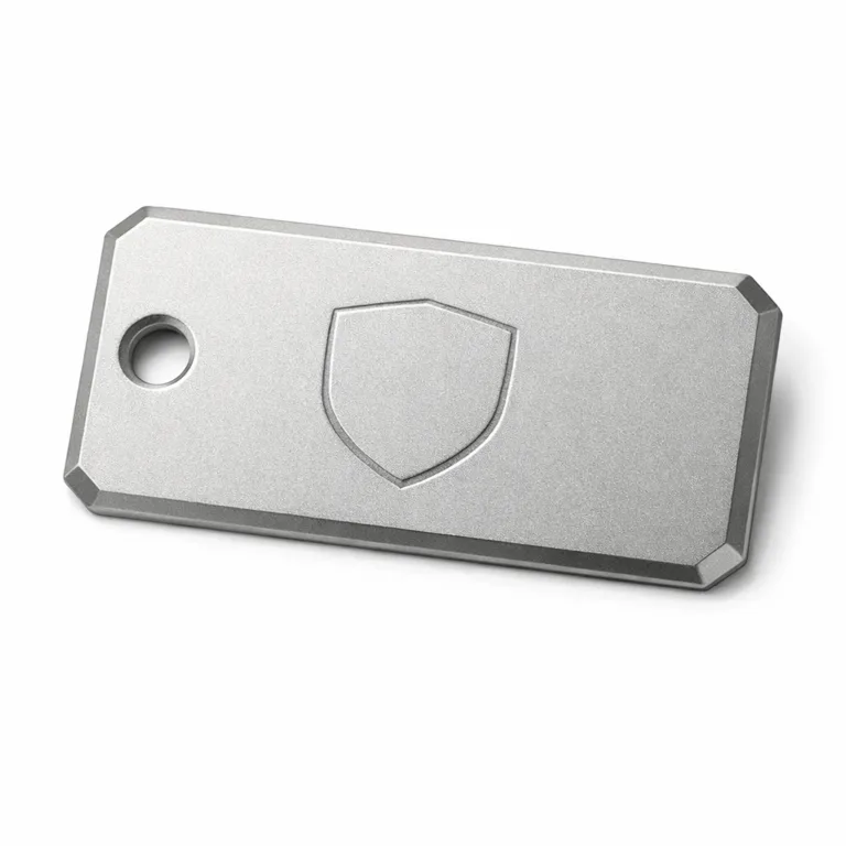 Matte nickel garment tag in anodized aluminum with a sandblasted matte texture, beveled edge detailing, single rivet hole, and a blank emblem laser engraved. Perfect for a modern, subtle look.