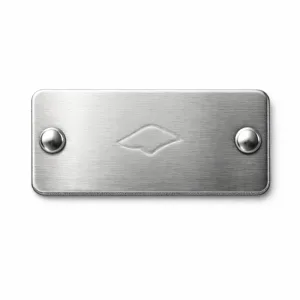 Rectangular brushed stainless steel garment tag designed for rivet attachment, featuring double clean holes and rounded corners. The front shows a subtle embossed logo emblem without text, making it ideal for premium branded garments.