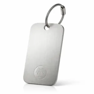 A high-realism luggage tag crafted from brushed stainless steel, featuring rounded corners, a delicately etched emblem, and a single hole designed for a split ring attachment. Ideal for sleek, modern travel accessories.
