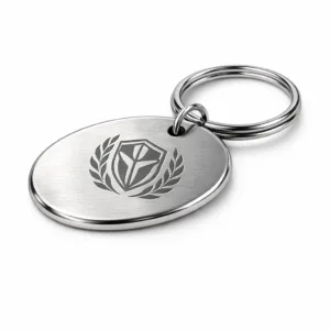 An oval brushed stainless steel keychain tag featuring a polished surface, rounded corners, and subtle laser engraving. Displayed with a single split ring attachment, captured in studio lighting for sharp detail.