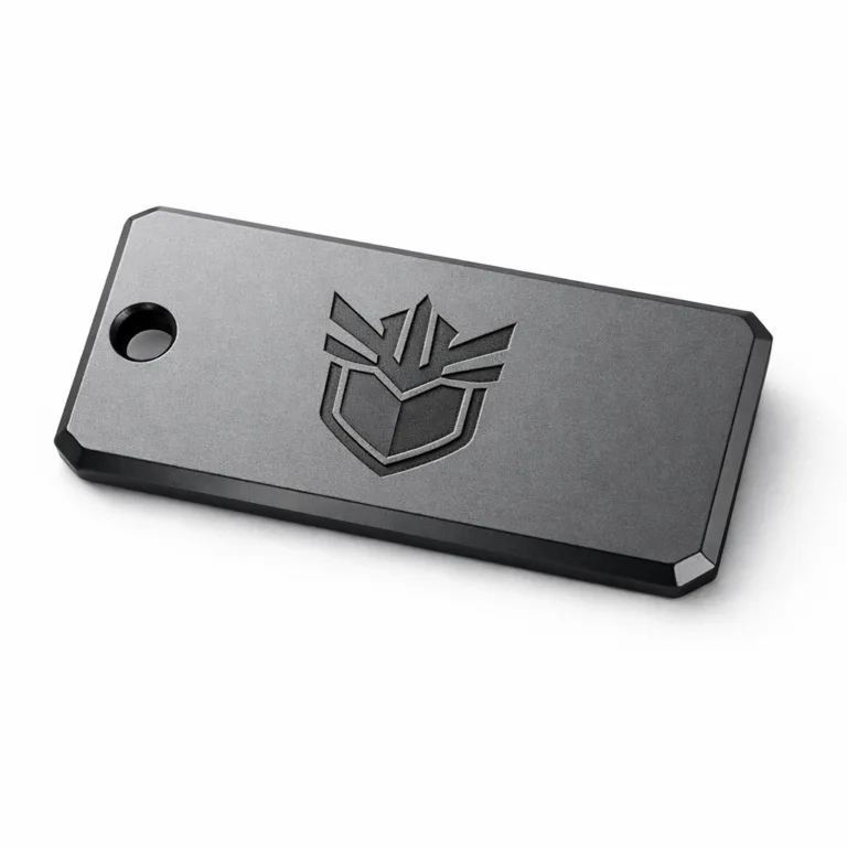 Product shot of a matte anodized aluminum logo tag featuring a laser engraved blank emblem and beveled edge. Designed for durability and modern branding, displayed on a crisp white background.