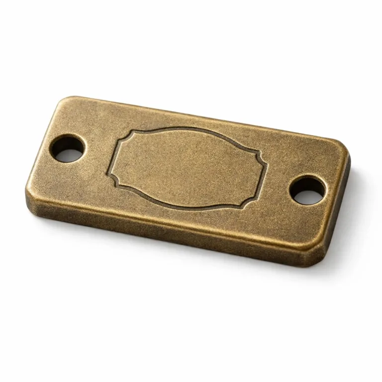 This antique brass logo tag is manufactured with a sandblasted matte texture and thickened profile, featuring an embossed blank logo shape. Ideal for vintage or luxury branding.