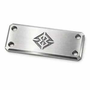 A rectangular cut-out logo tag made from brushed stainless steel, featuring beveled edges, a laser engraved emblem (no readable text), and double mounting holes for secure attachment. Perfect for showcasing durable and modern branding.