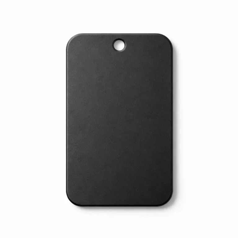 High-realism image of a matte black anodized aluminum luggage tag with smooth rounded corners and a single central hole for easy chain attachment. The tag displays a durable, contemporarily styled finish.