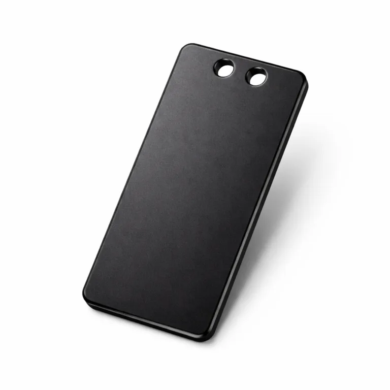 A stylish anodized aluminum luggage tag with a matte black finish, beveled edges, and double holes suitable for secure split ring or ball chain attachment.