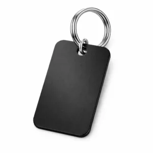 A single matte black aluminum keychain tag featuring a brushed texture for a sophisticated look. Rounded corners and a silver split ring make this tag durable and easy to attach to keys.