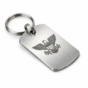 High realism studio photo of a brushed stainless steel bag tag nameplate, featuring rounded corners and a blank emblem created with laser engraving. Includes a split ring for attachment. Ideal for modern luggage or bags.