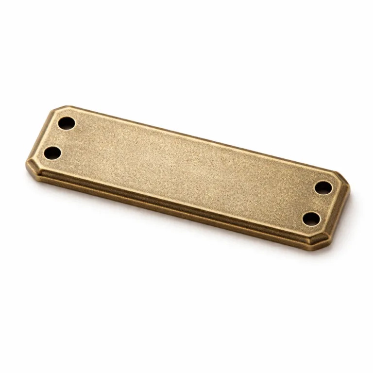 Classic antique brass bar bracelet tag with a sandblasted matte finish, chamfered edges for visual depth, two sewing holes for easy attachment, and a finely etched blank emblem on the front.