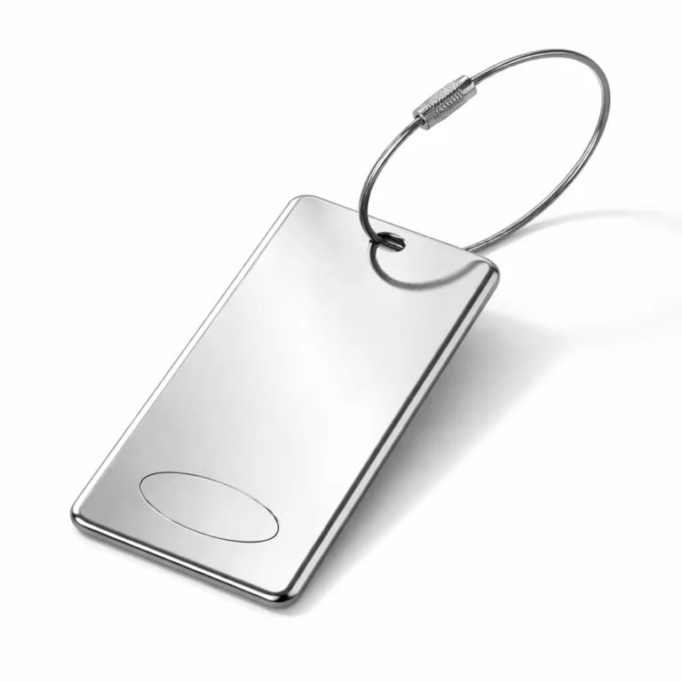 A luggage tag made from brushed stainless steel with a mirror polished surface and elegant chamfered edges. The tag displays a blank laser-engraved emblem shape on the front, and its precise construction and reflective finish are highlighted in this e-commerce image.