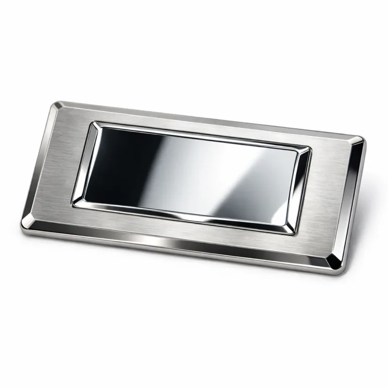 Stainless steel logo tag with a brushed surface and shiny nickel plating, featuring a debossed logo detail and sharp beveled edges. Photographed in a crisp studio environment highlighting its premium metallic texture.