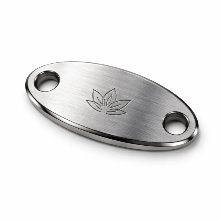 A high-quality oval bracelet tag made from brushed stainless steel, featuring a clean beveled edge and double attachment holes. The front displays a laser engraved blank emblem, emphasizing modern precision and premium durability.