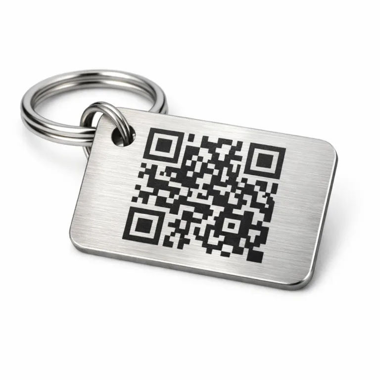 A keychain tag manufactured from brushed stainless steel, featuring a single hole for attachment and a laser engraved QR code pattern. The tag has rounded corners for a modern, smooth appearance—ideal for durable everyday use.