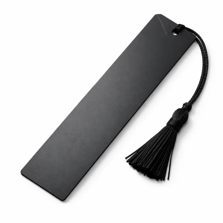 A realistic photo of a matte black anodized aluminum bookmark tag, featuring chamfered edges and a subtle etched surface pattern. The matte finish and clean lines create a modern appearance.