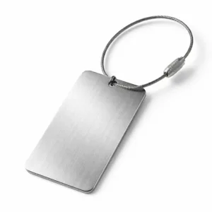 A brushed stainless steel luggage tag designed for serial numbers, with rounded corners and a crisp laser engraved face, photographed in a minimalist studio setup.