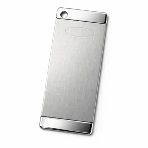 A two-tone bookmark tag manufactured in stainless steel, featuring a brushed main surface with contrasting polished edges. The rectangular design has rounded corners, a single hole on the top left for optional attachment, and a subtle blank emblem for customization.