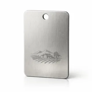A Vineyard Series Wine Tag made from brushed stainless steel, featuring a clean engraved blank emblem, smooth rounded corners, and a single hanging hole. Photographed for clarity and fine detail.