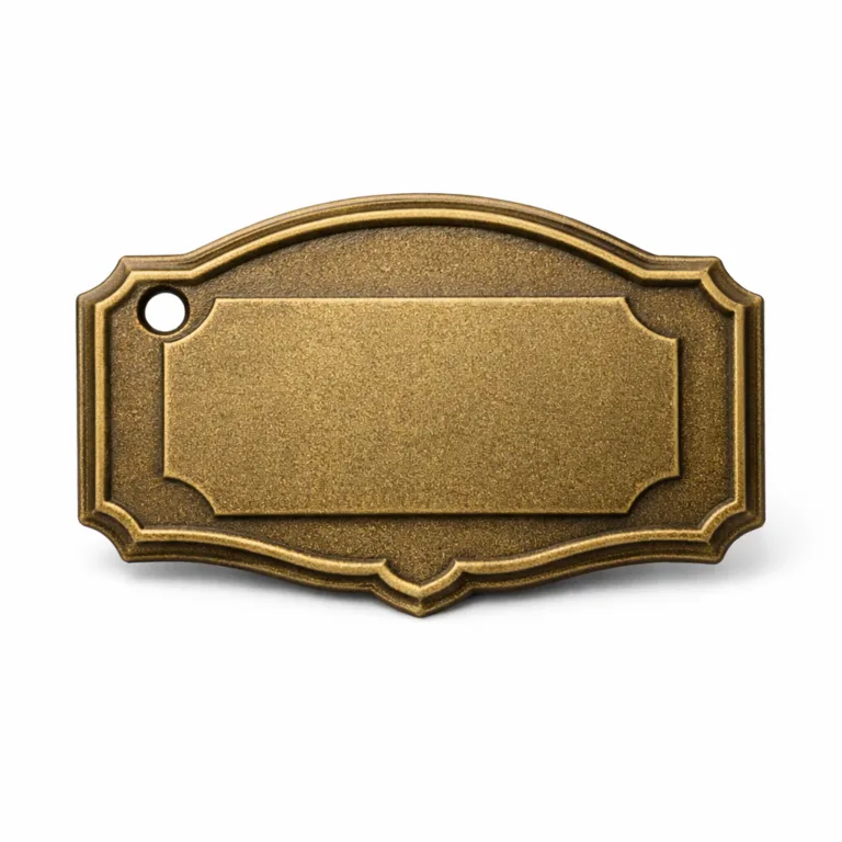 Photo of a wine tag plate in antique brass with a sandblasted matte surface, chamfered edge detail, and raised embossed blank emblem; features one hole for hanging, suitable for vintage-themed identification.