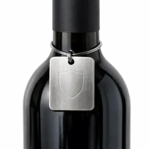A brushed stainless steel effect wine neck tag made from zinc alloy, featuring rounded corners and a blank emblem created with subtle laser engraving, secured to the bottle with a sleek split ring.