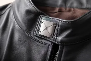 A detailed closeup of a contemporary fashion garment with a custom metal sew-on label, emphasizing the sophistication and branding power of metal tags.