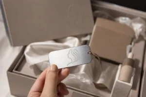 A premium influencer kit presentation featuring a personalized metal tag placed on high-end packaging for social media unboxing content.